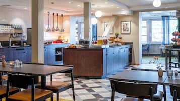 A modern hotel lobby with a central bar area, seating arrangements, and a check-in counter.