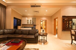 Presidential Suite | Living area | 46-inch LED TV with cable channels, TV, DVD player