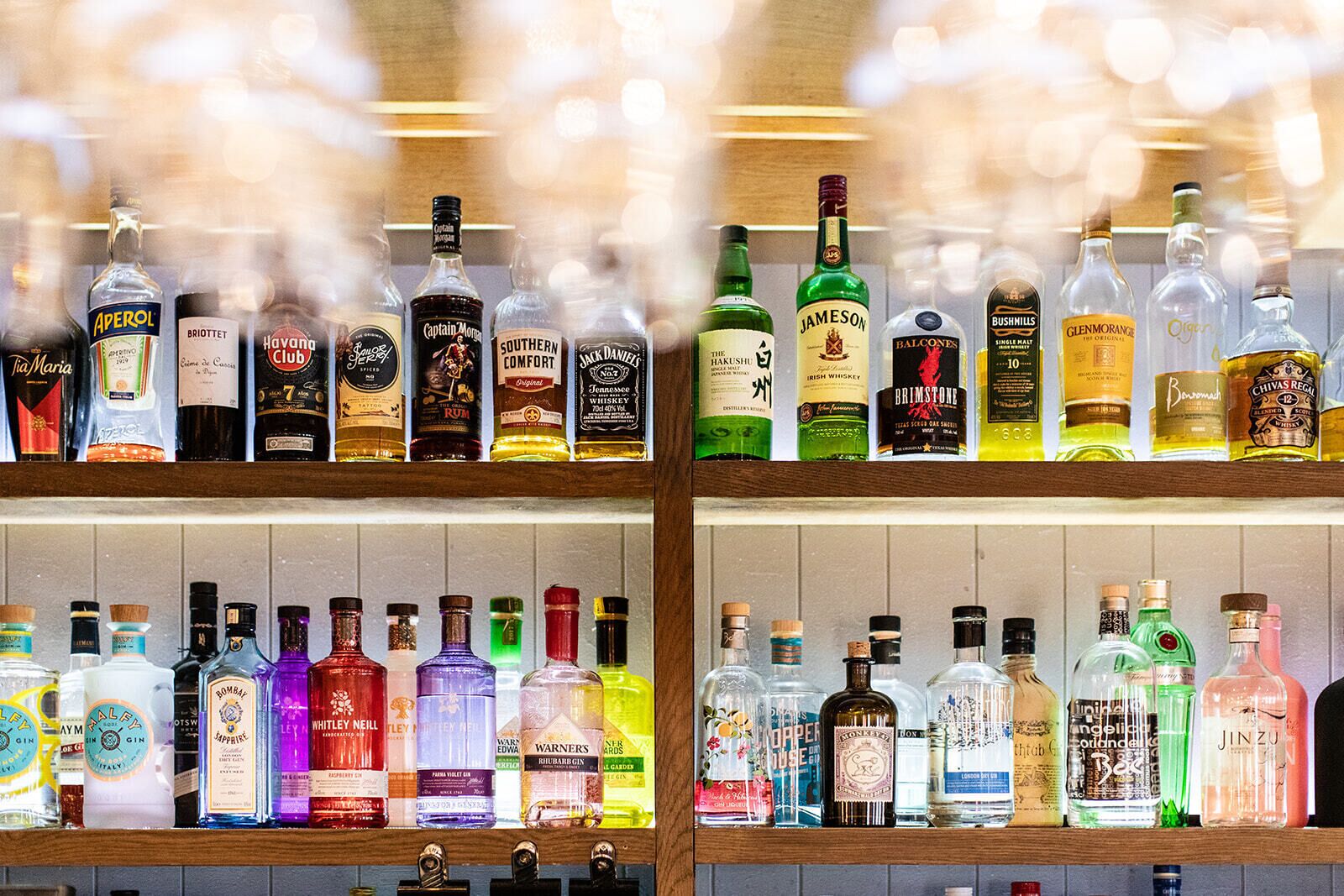 A bar with various bottles of alcohol on shelves.