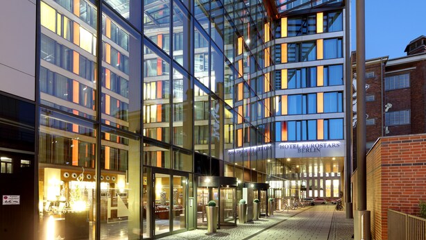 Un hôtel moderne doté de grandes fenêtres en verre, d’une entrée bien visible et d’une enseigne indiquant « HÔTEL EUROSTARS BERLIN ».