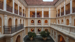 A courtyard with a central open space surrounded by multiple balconies with railings. - Grand Hyatt Goa (Panaji)