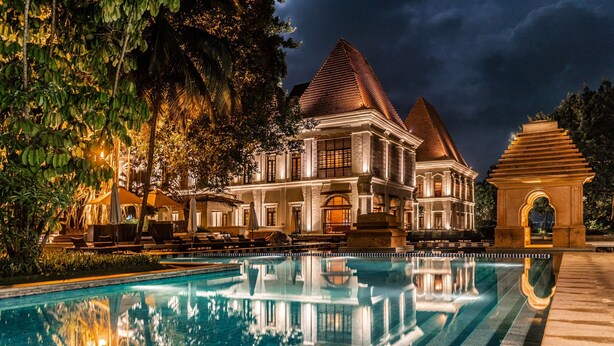 A large, illuminated building with a pool in front. - Grand Hyatt Goa (Panaji)