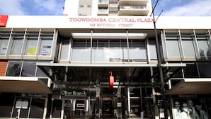 Toowoomba Central Plaza with a modern facade, multiple balconies, and storefronts including Olive Branch Lounge Bar and Restaurant.