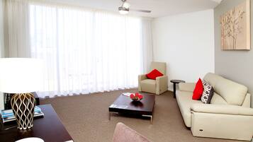A modern living room with a sofa, a coffee table, and a lamp.