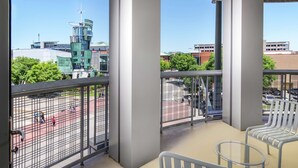 A balcony with a view of a sports court, metal railings, and a seating area with chairs. - Hampton Inn & Suites Chattanooga/Downtown (Chattanooga)