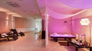 A spa room with massage tables, a reception desk, and a reception area.