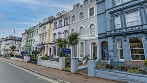 A row of Victorian-style buildings with signs for 'The Belmont' and 'The Albion Hotel'. - The Belmont (Torquay)