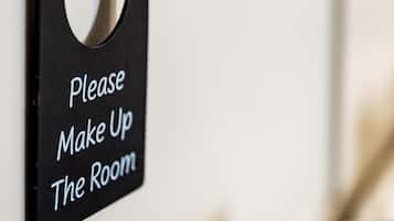 A sign on a wall that reads "Please Make Up The Room".
