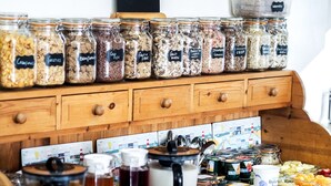 A breakfast bar with various food items and beverages. - Toulson Court (Scarborough)