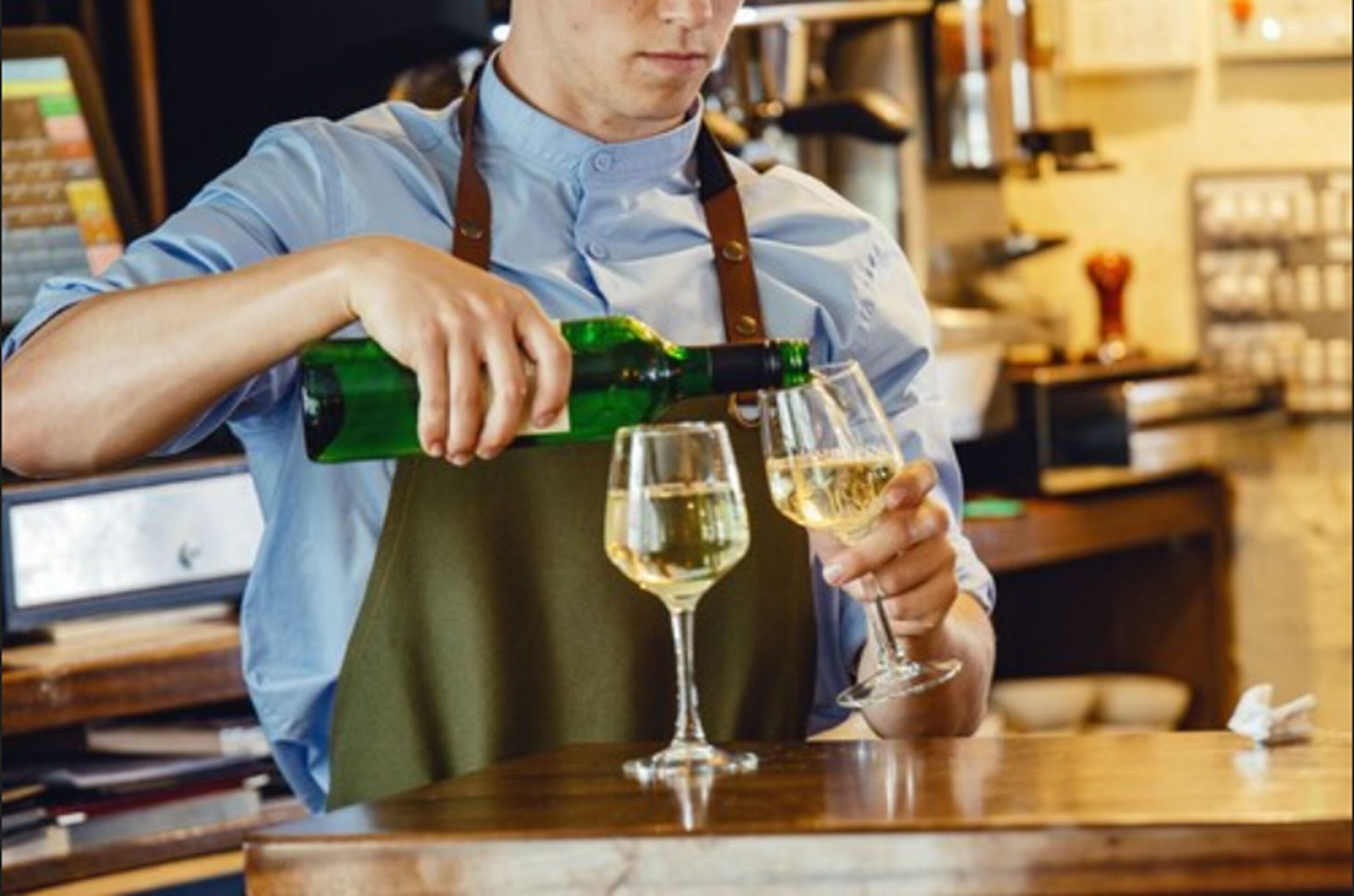 A person pouring a drink into a glass.