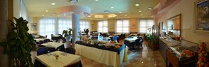 A spacious dining area with multiple tables, a buffet counter, and large windows allowing natural light. - Eden (Valeggio sul Mincio)