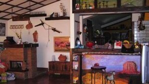 A cozy room with a fireplace, wooden shelves, and a rustic decor. - Maya (Zagarolo)