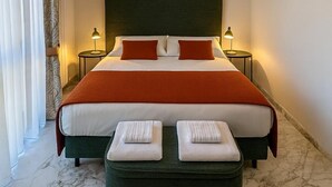 A hotel room with a large bed, two bedside tables, a headboard, and a marble floor. - Antella Residence (Bagno a Ripoli)
