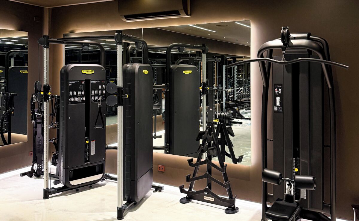 A gym with various exercise machines, including weight stacks and cardio equipment.