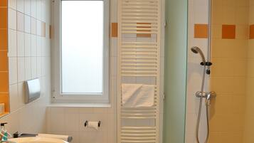 A bathroom with a sink, toilet, and shower.