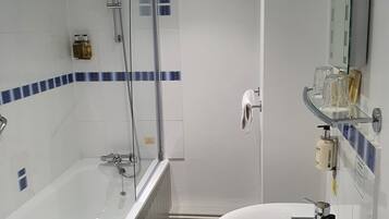 A modern bathroom with a bathtub, a sink, and a shower.