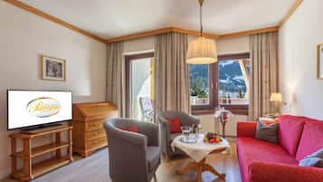 Suite de lujo, balcón | Área de sala de estar | Televisión de pantalla plana