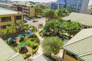 A courtyard with outdoor seating, palm trees, and a parking area. - Boma Inn Nairobi (Nairobi)