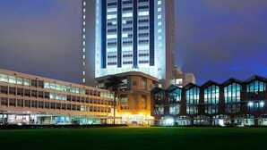 A multi-story hotel with a modern design, featuring a prominent central tower and a series of connected buildings. - Boma Inn Nairobi (Nairobi)