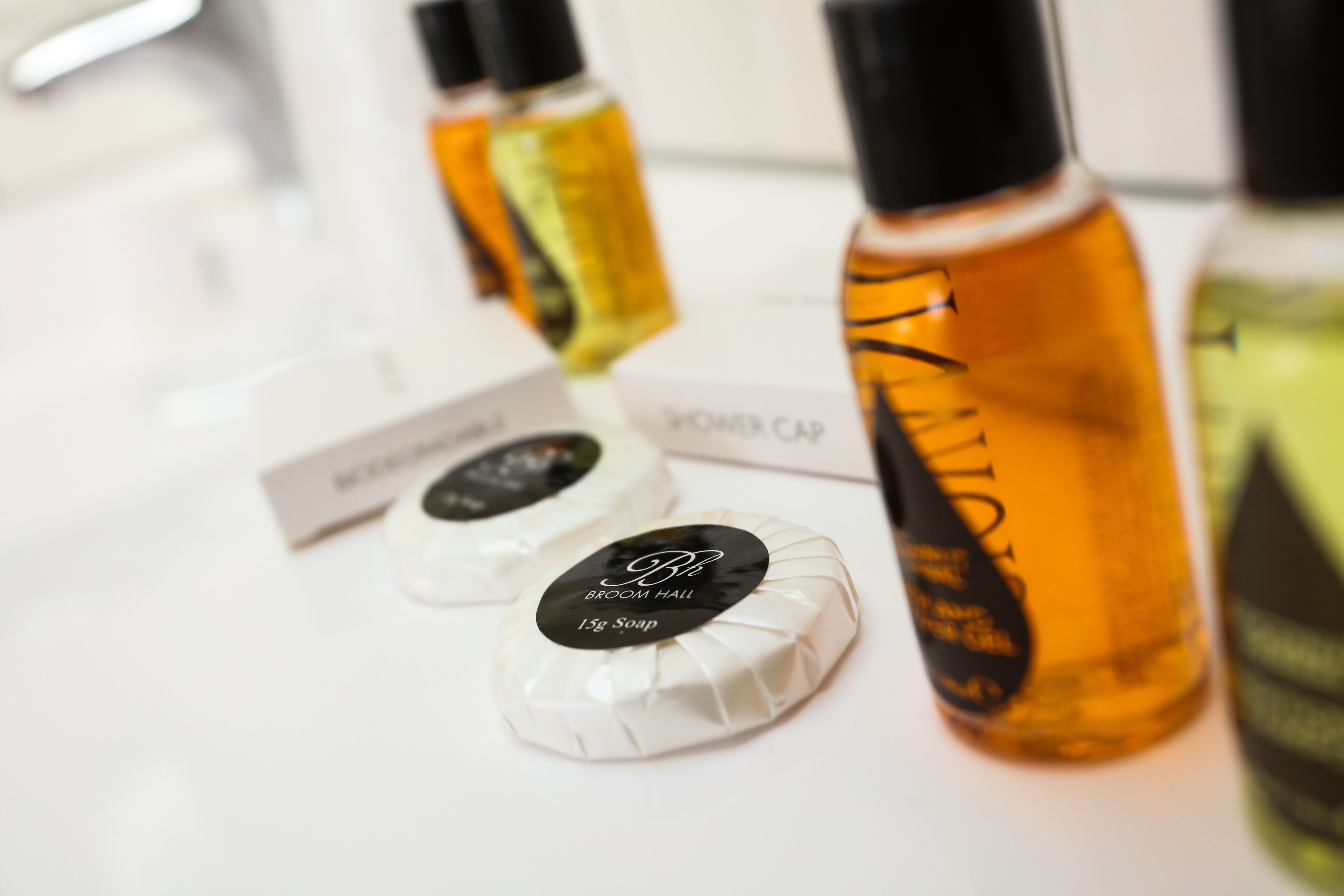 A variety of toiletries including a bottle of shampoo, a bottle of conditioner, and a bottle of body wash.