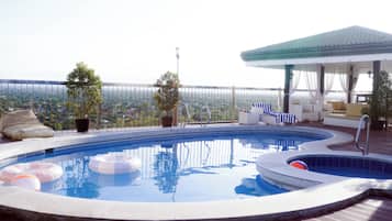 Outdoor pool, open 7:00 AM to 9:00 PM, pool loungers