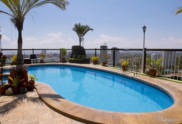 Outdoor pool, open 7:00 AM to 9:00 PM, pool loungers