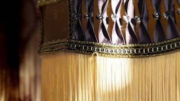 A close-up of a fabric with fringe detailing and decorative elements.