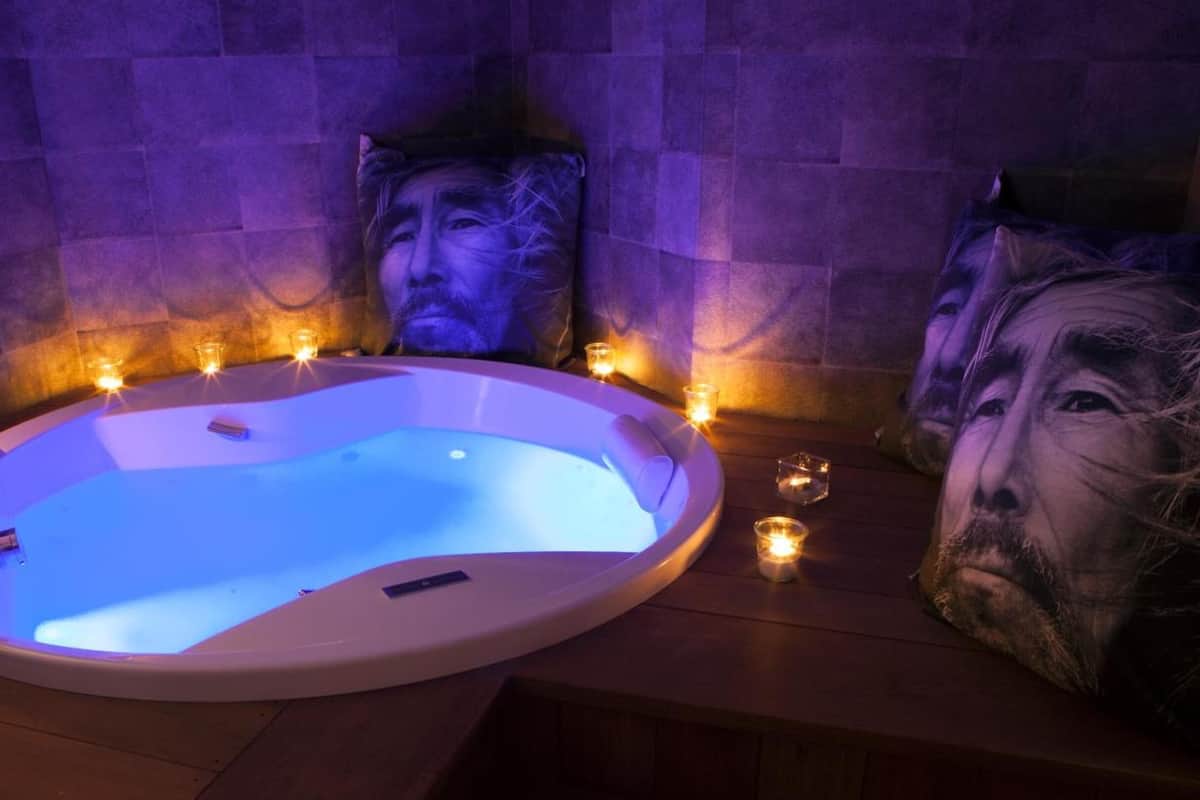 bathtub, hair dryer, bathrobes, slippers