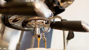 A coffee machine dispensing espresso into a cup.