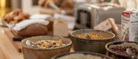 A breakfast buffet with various food items and bowls.