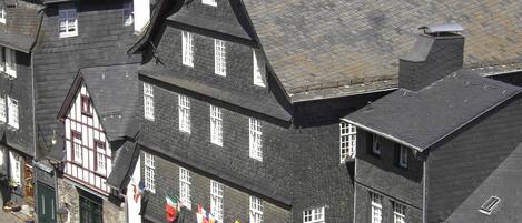 A traditional European building with multiple windows and a prominent clock tower.