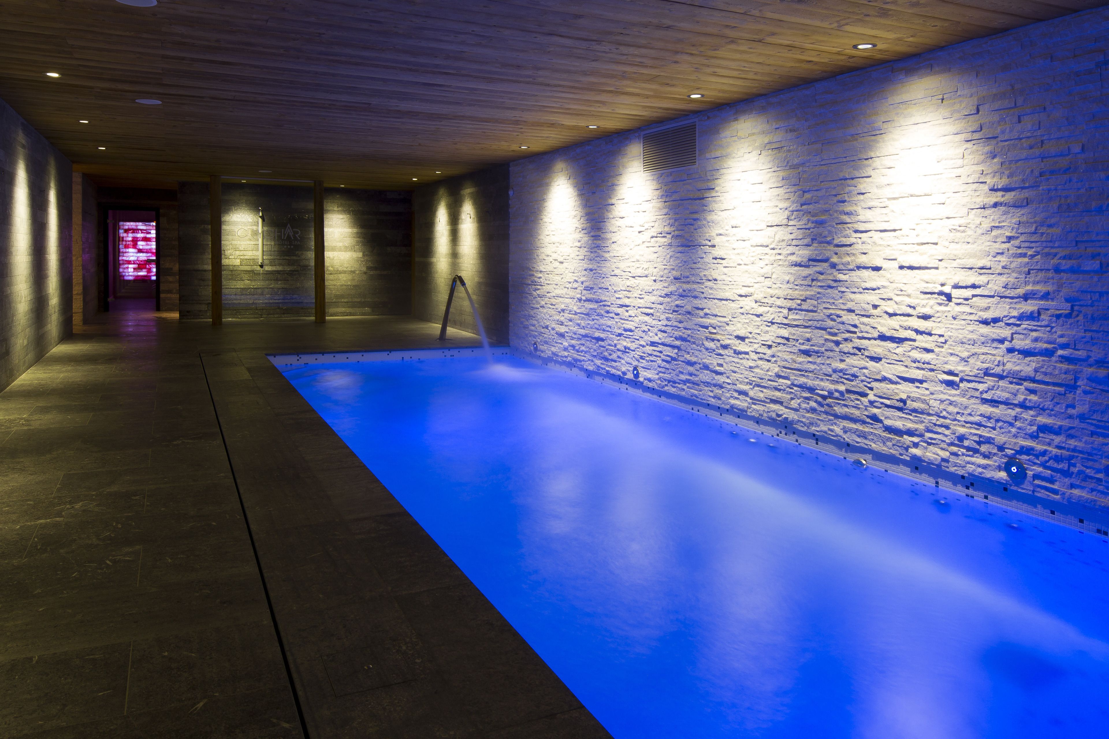 Indoor pool, a waterfall pool, pool loungers