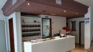 A reception desk with a clock, a bulletin board, and a sign indicating the direction to the restroom and restaurant. - Hotel Florida (Piove di Sacco)