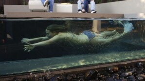 A swimming pool with a person swimming. - Alpine Attitude Boutique Hotel & Conference Venue (Pretoria)