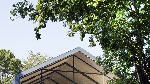 A modern building with a large glass facade, outdoor seating area, and a covered patio. - Alpine Attitude Boutique Hotel & Conference Venue (Pretoria)