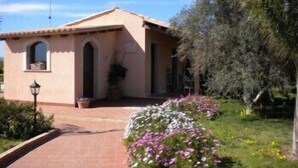 A small, single-story building with a tiled roof and arched windows. - Villa Cristina (Syracuse)