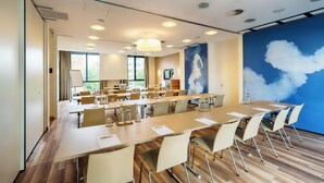 A conference room with a long table, chairs, and a large window. - Best Western Plus Welcome Hotel Frankfurt (Frankfurt)