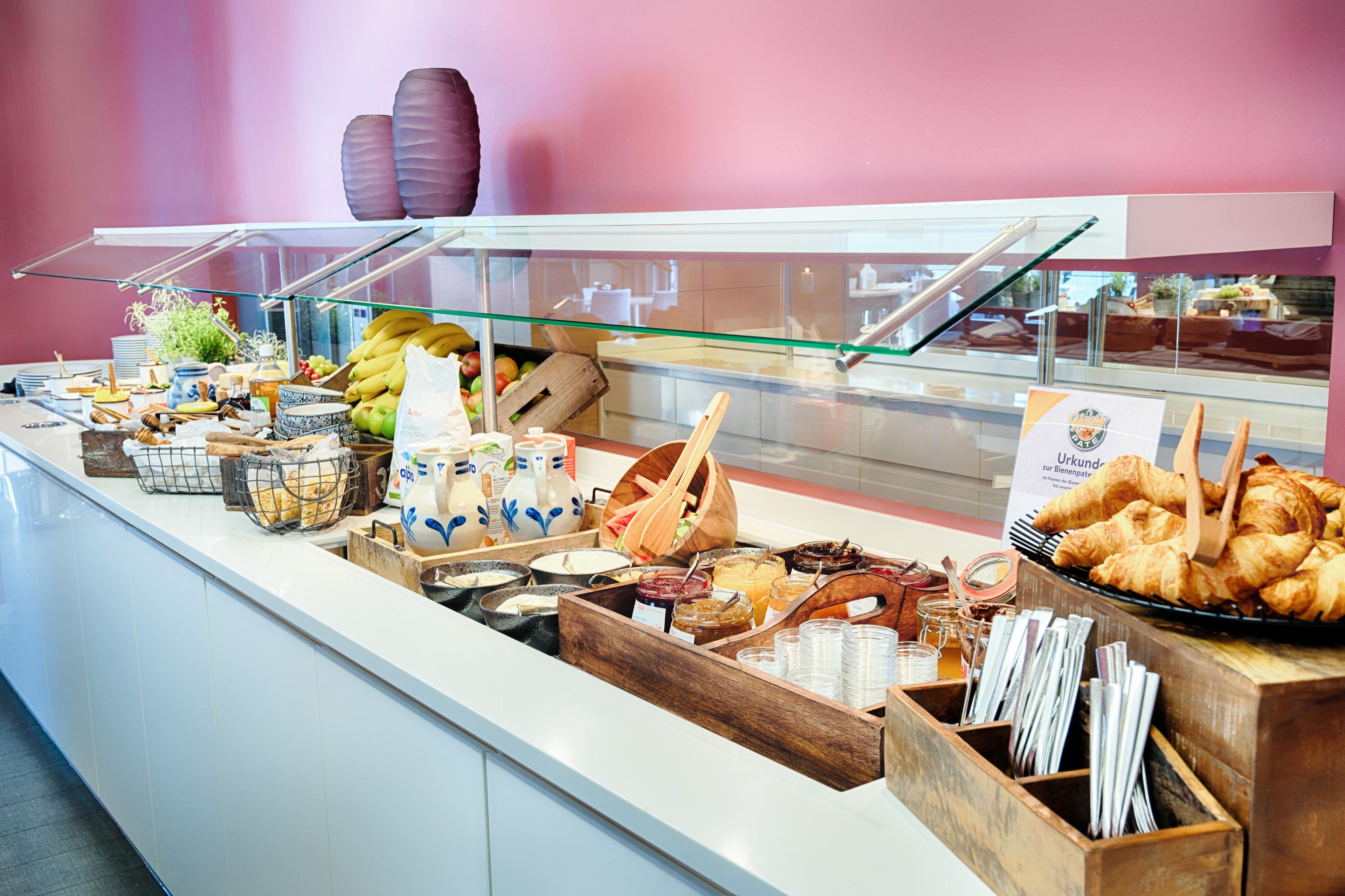 A buffet with various food items and condiments.
