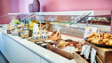 A buffet with various food items and condiments.