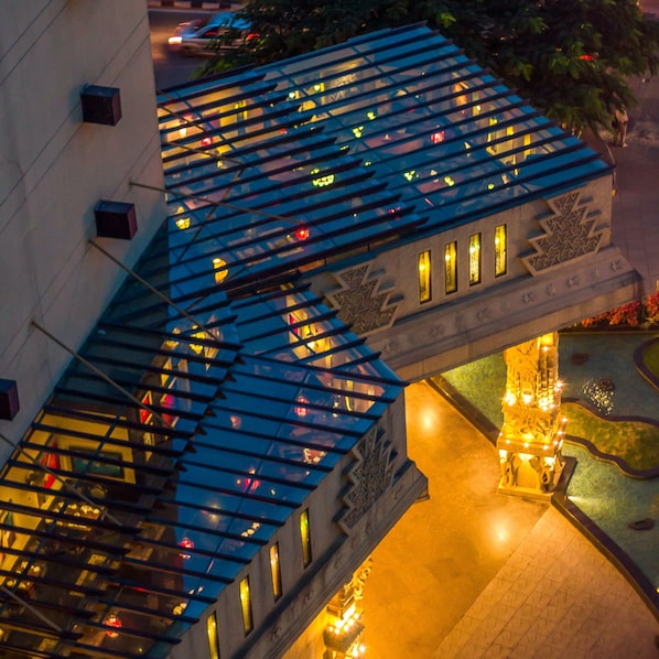 A multi-level building with a glass facade and a decorative bridge. - Sterlings Mac Hotel (Bengaluru)