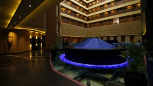 A multi-level atrium with a central water feature and a patterned ceiling. - Sterlings Mac Hotel (Bengaluru)