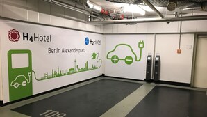 A H4Hotel Berlin Alexanderplatz parking area with electric vehicle charging stations and a digital payment kiosk. -  Leonardo Smart Hotel Berlin City East  (Berlin)