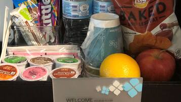 A variety of food items including snacks, drinks, and breakfast items in a tray.