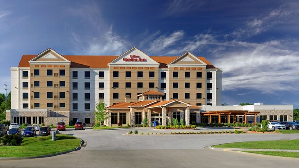 A large, multi-story hotel with a prominent "Hilton Garden Inn" sign.