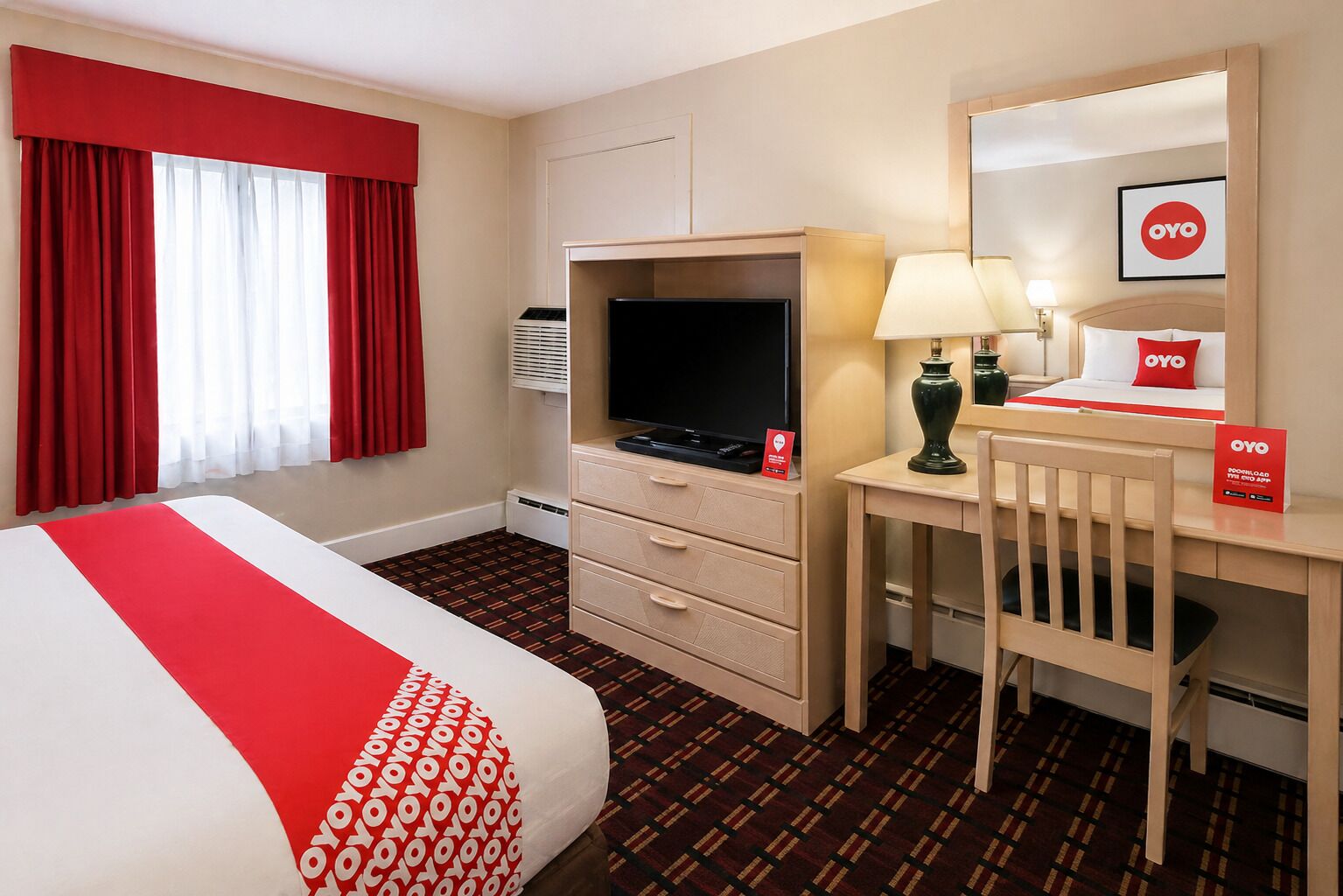 A hotel room with a bed, a desk, a television, a lamp, and a mirror.