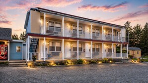 A two-story motel with a porch, multiple rooms, and a gravel driveway. - OYO Hotel Starlite Seneca Falls (Seneca Falls)