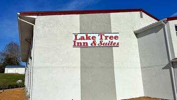 A building with a sign reading "Lake Tree Inn & Suites".