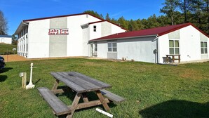 A building with a sign reading "Lake Tree Inn & Suites" and a picnic table in front. - Laketree Inn And Suites Marion (Marion)