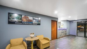 A reception area with two armchairs, a small round table, and a welcome sign. - Super 8 by Wyndham Munfordville KY (Munfordville)