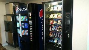 A vending machine with Pepsi branding and a selection of snacks. - Super 8 by Wyndham Munfordville KY (Munfordville)